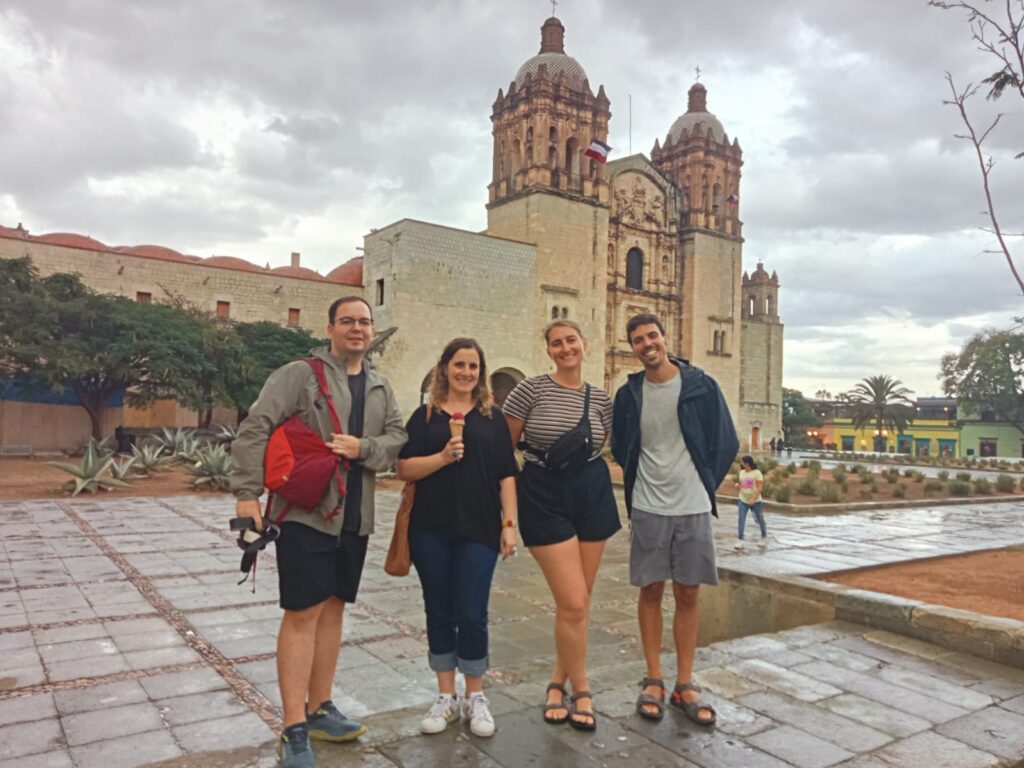 People in front of a church during free walking tour in Oaxaca, Mexico