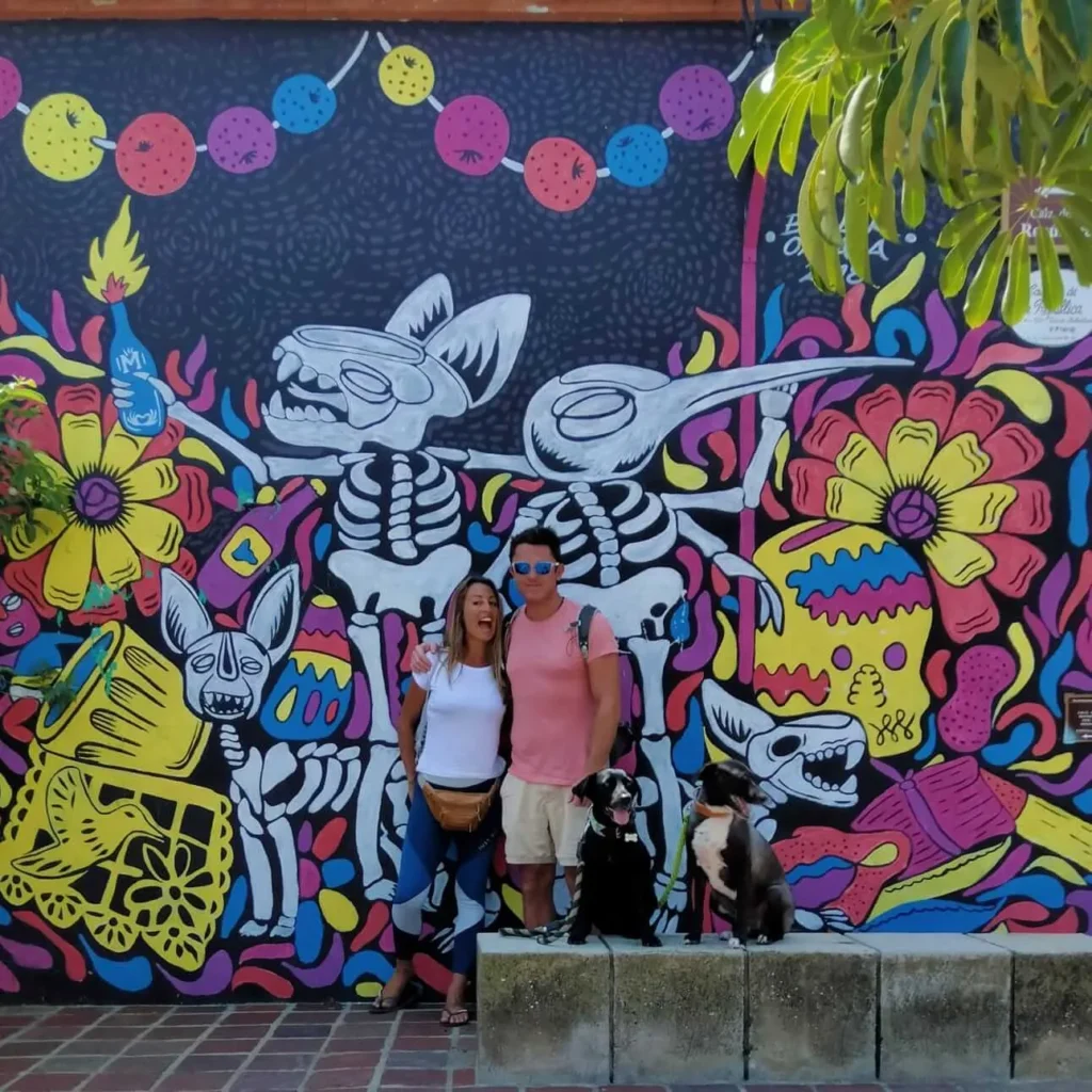 Oaxaca art walk Tour with cultura distinta. Group picture outside of a colourfully painted house