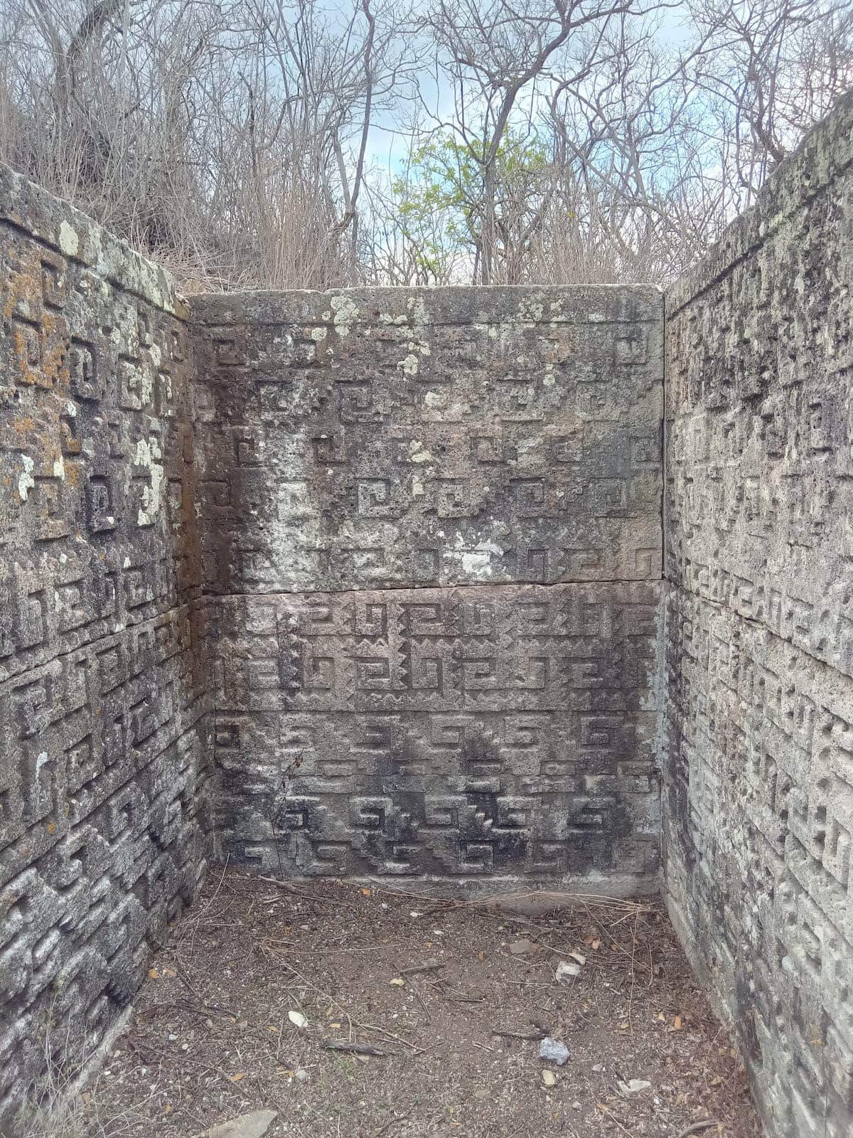 Pre Hispanic walls in cruciform tombs with carvings