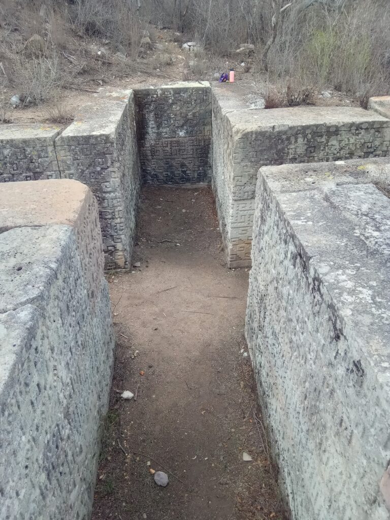 Cruciform tomb with pre Hispanic carvings on the walls near Oaxaca Mexico