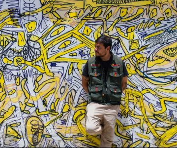 Person in front of graffiti piece San Cristobal, Mexico
